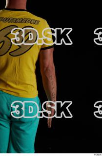 Arm flexing reference of body yellow shirt turquoise shorts brown…